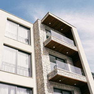 Modern multi-storey hotel with terraces with glass railings. High quality photo